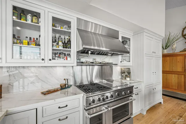 a kitchen with a sink stove and cabinets