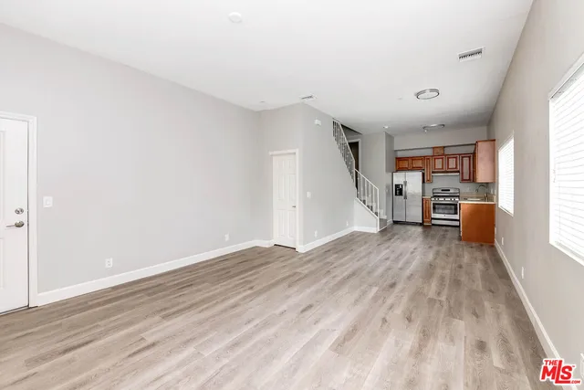 a view of a kitchen with furniture and wooden floor