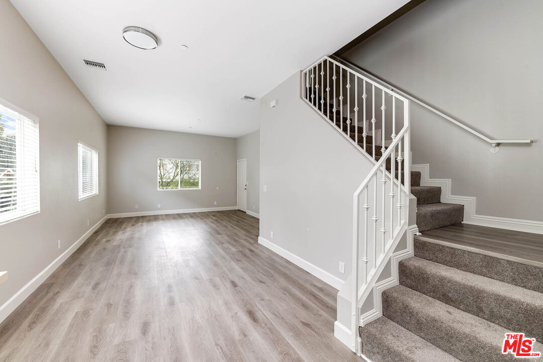 14735 Friar Street, Unit 101 Van Nuys, CA 91411 - Photo 8 of 16 a view of entryway and hall with wooden floor