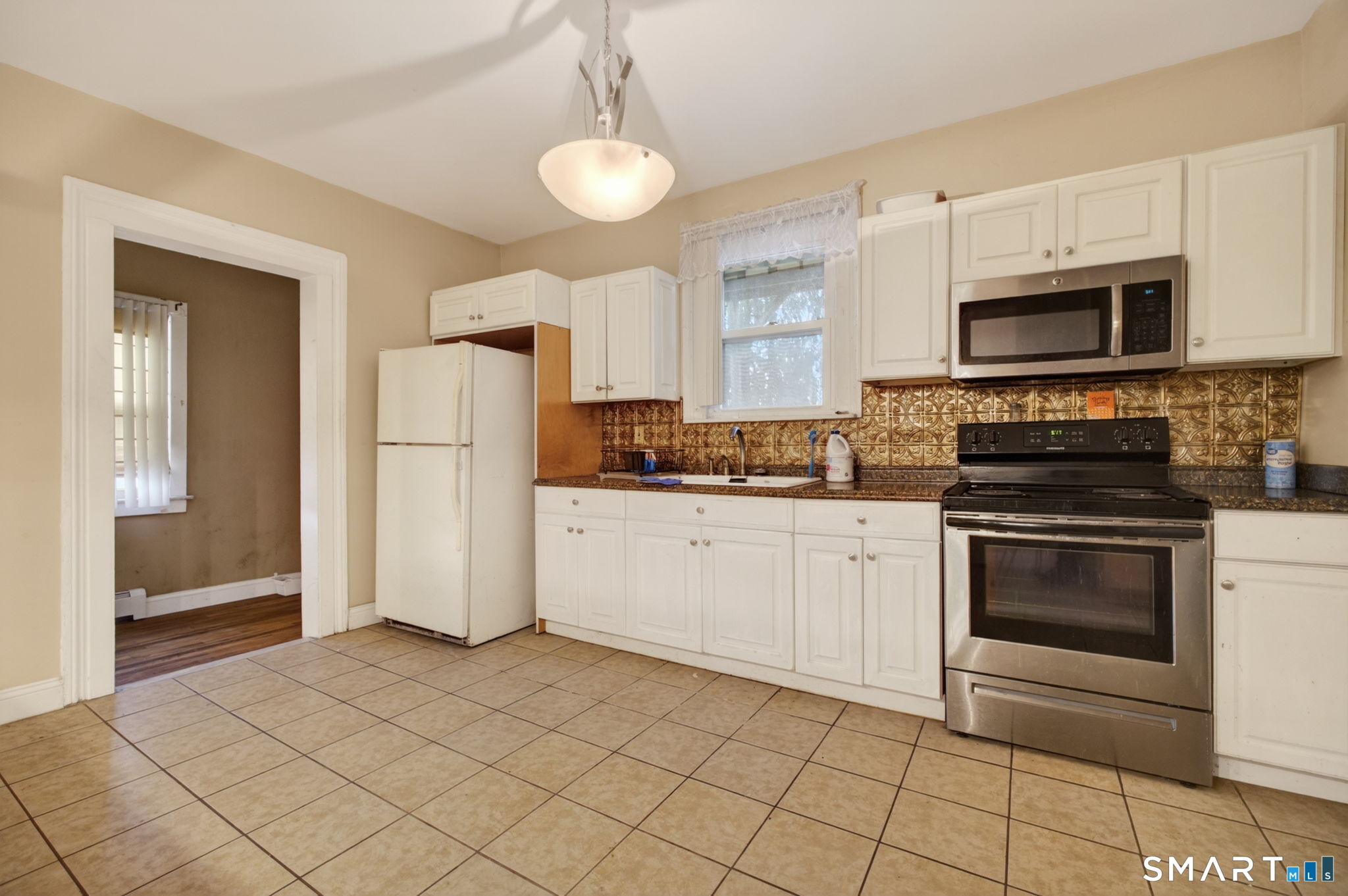 670 Hanover Road Meriden, CT 06451 - Photo 14 of 40 a kitchen with stainless steel appliances granite countertop a stove a sink and a refrigerator