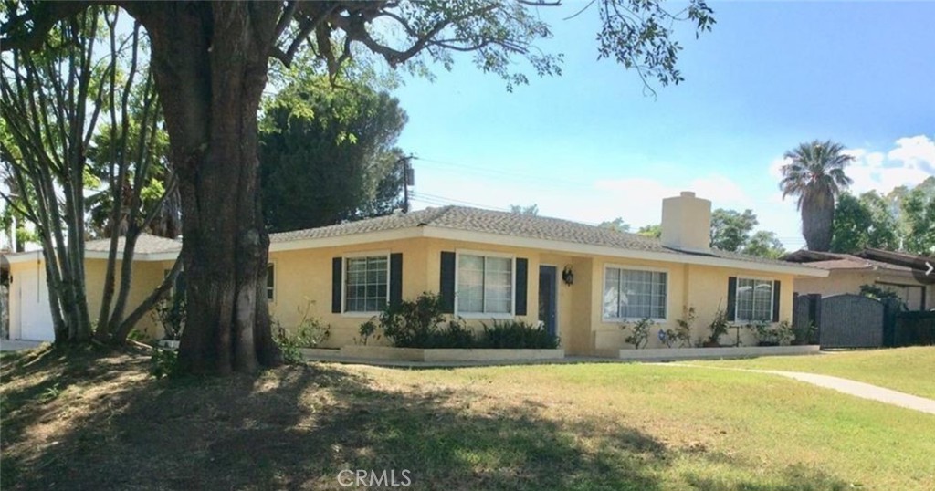 5896 Olive Avenue Rialto, CA 92377 - Photo 1 of 1 a front view of a house with garden