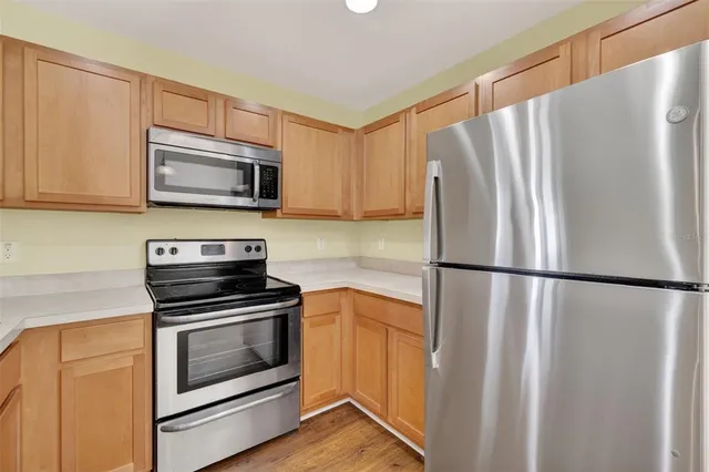 a kitchen with a refrigerator stove and microwave