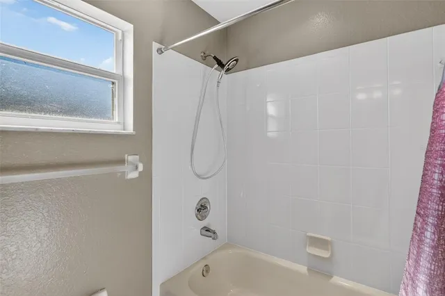 a bathroom with a shower and a bathtub