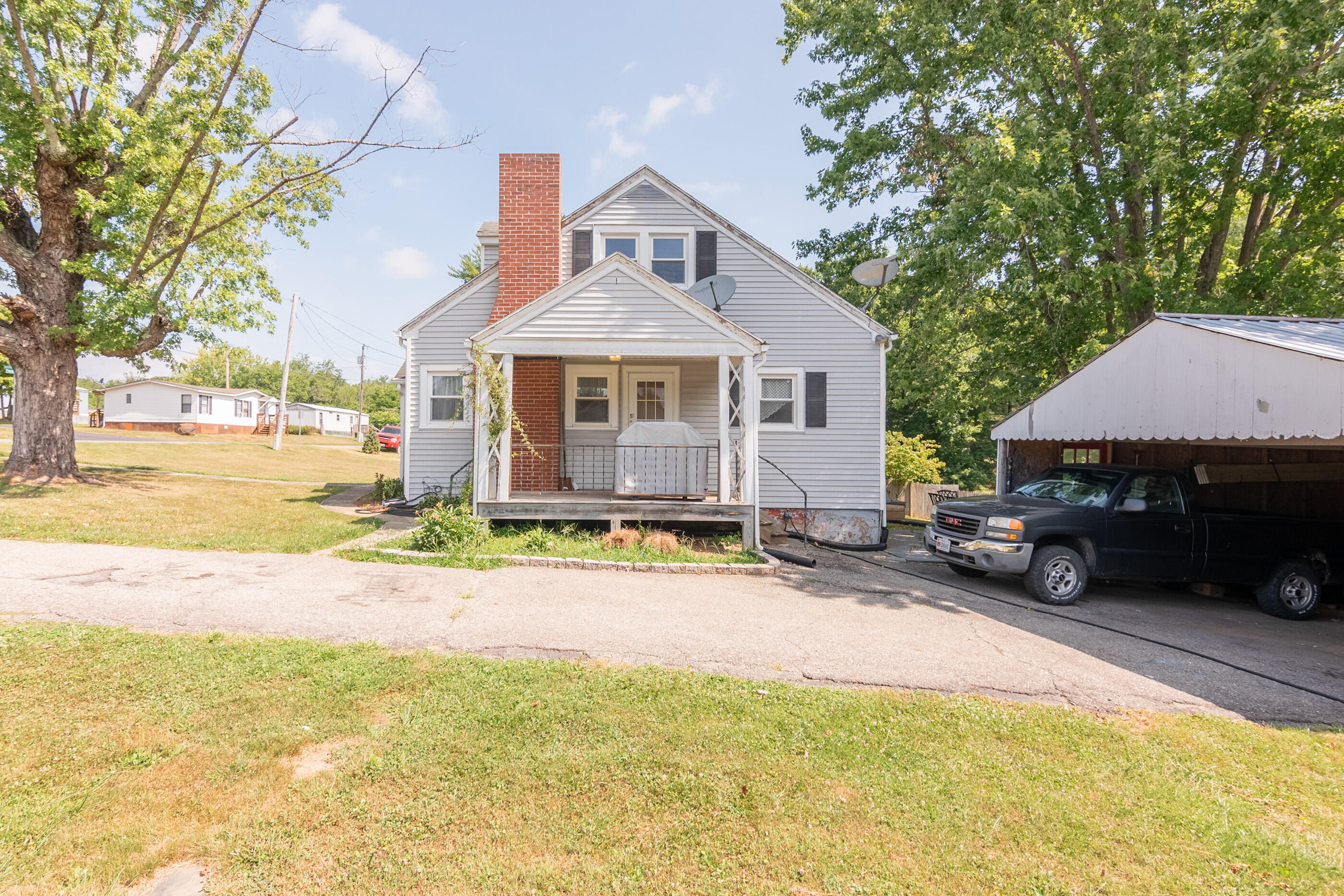 223 Newtown Road Northeast Floyd, VA 24091 - Photo 33 of 44 a view of a house with a patio and a yard