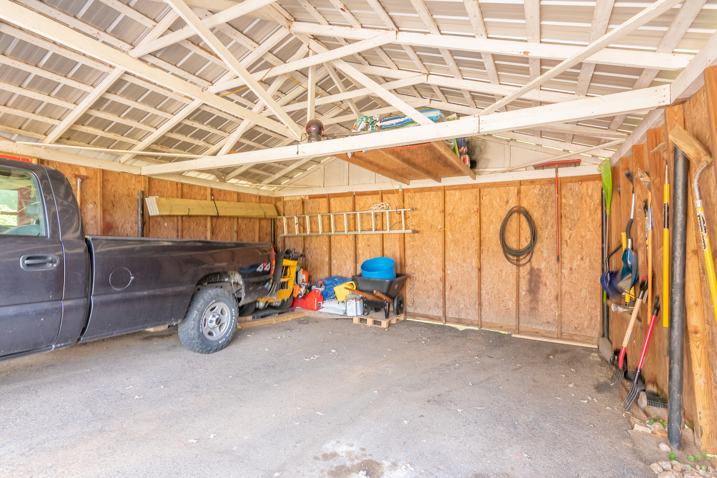 223 Newtown Road Northeast Floyd, VA 24091 - Photo 34 of 44 a view of a garage with a bike and a car