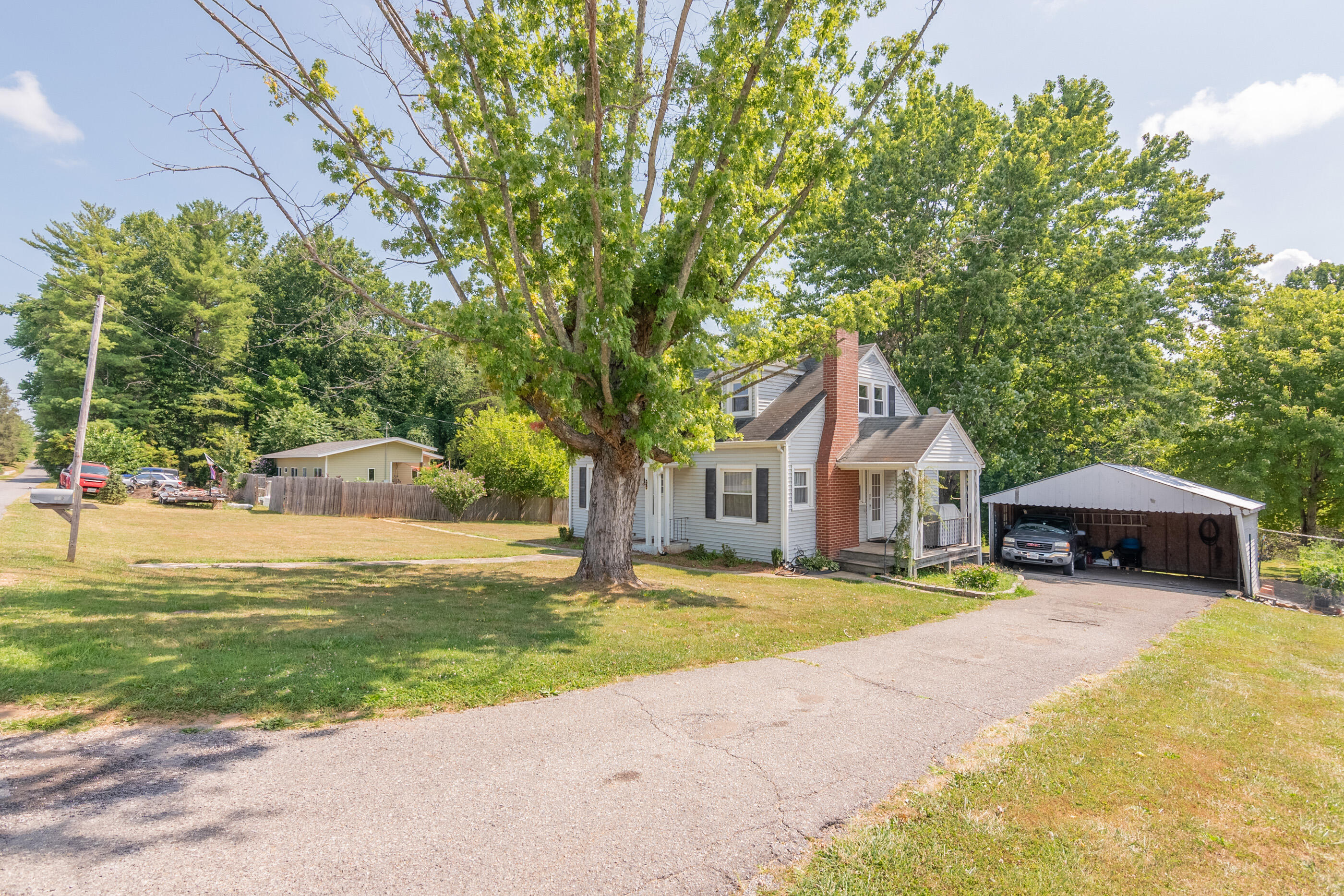 223 Newtown Road Northeast Floyd, VA 24091 - Photo 5 of 44 a front view of a house with a yard table and chairs