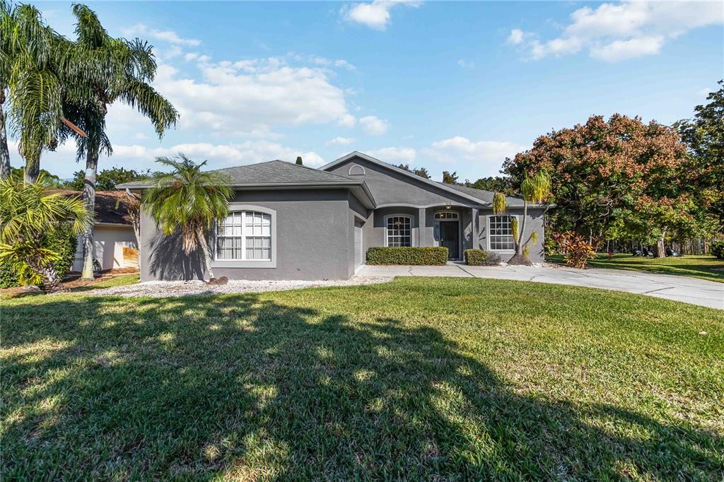 a view of a house with a backyard