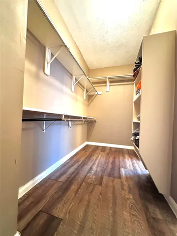 a view of a room with wooden floor and a window