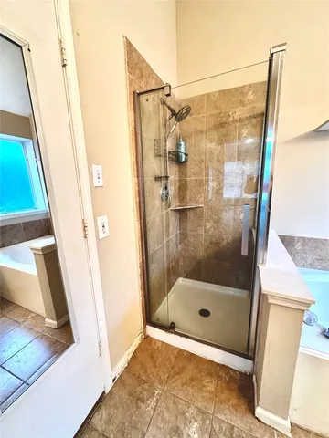 a view of a room with wooden floor and ceiling fan
