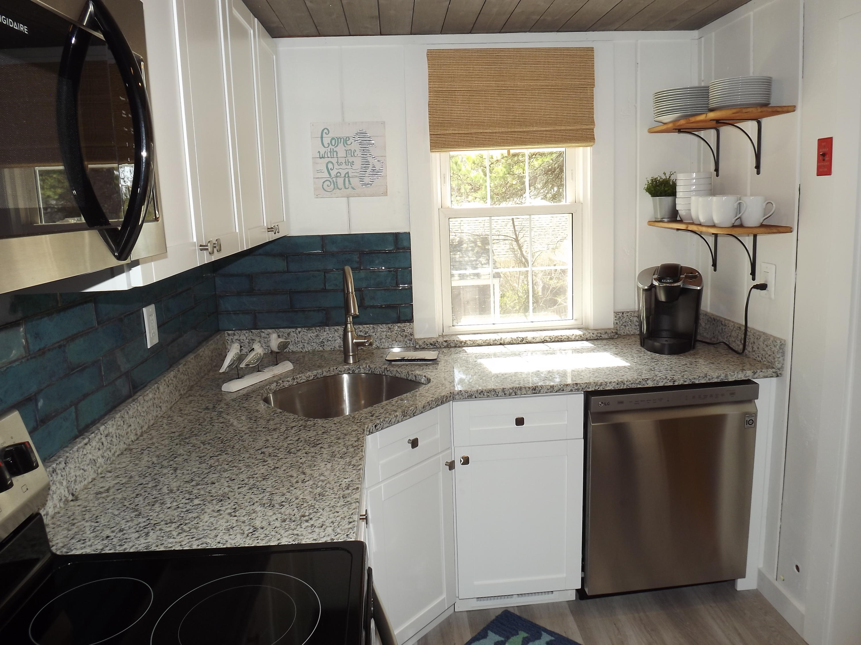 36 Tobey Turtle Road South Chatham, MA 02659 - Photo 9 of 21 a kitchen with stainless steel appliances granite countertop a sink stove and cabinets