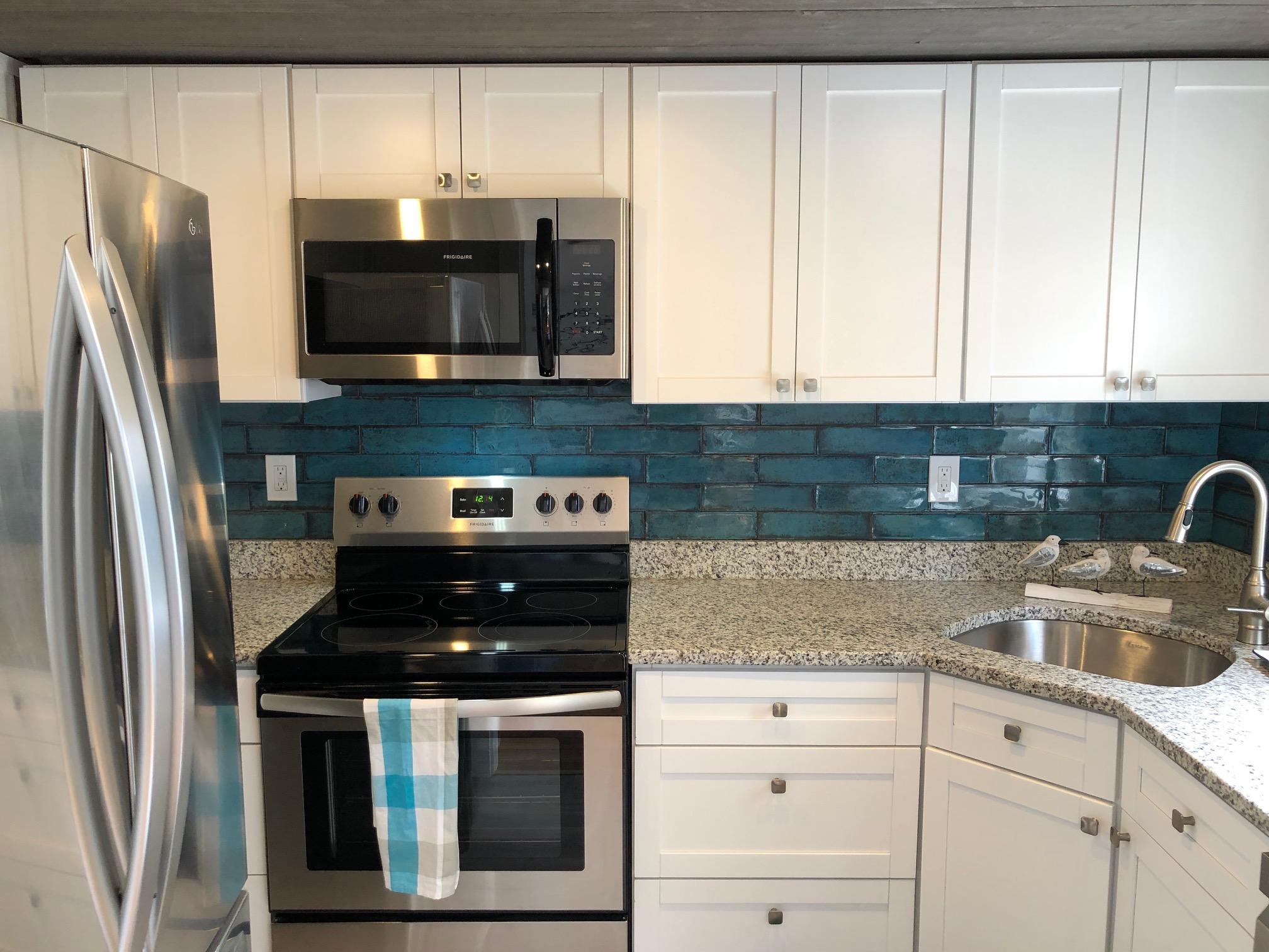 36 Tobey Turtle Road South Chatham, MA 02659 - Photo 10 of 21 a kitchen with stainless steel appliances granite countertop a sink stove and refrigerator