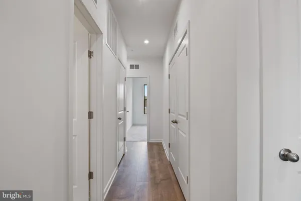 a view of a hallway with wooden floor and a hallway