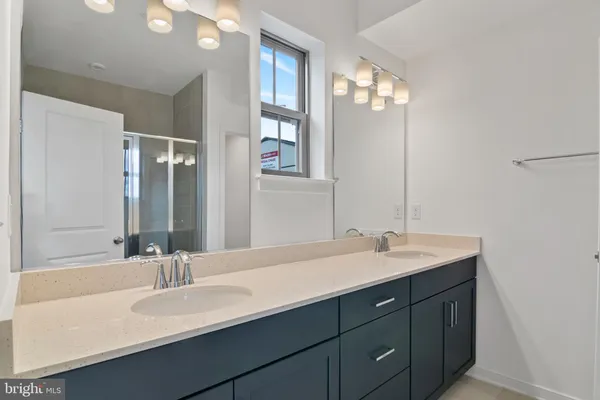 a bathroom with double vanity sinks and a mirror