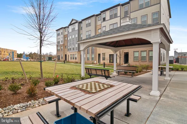 a view of a patio with table and chairs near a yard