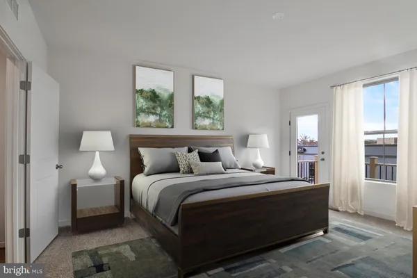 a bedroom with a bed and a large window