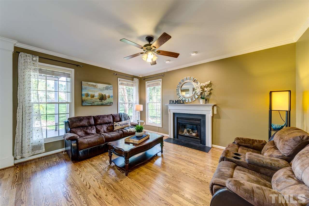 3709 Farmstone Drive Raleigh, NC 27603 - Photo 12 of 30 Bright and warm Family Room centered around fireplace! Views of private fenced rear yard!