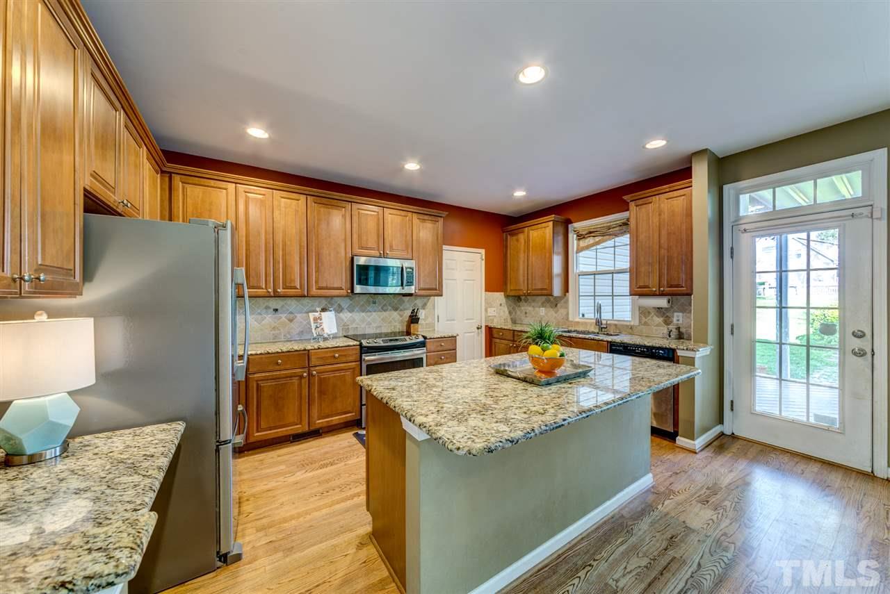 3709 Farmstone Drive Raleigh, NC 27603 - Photo 9 of 30 Plentiful counter and cabinet space- Granite, double sinks! Built in desk