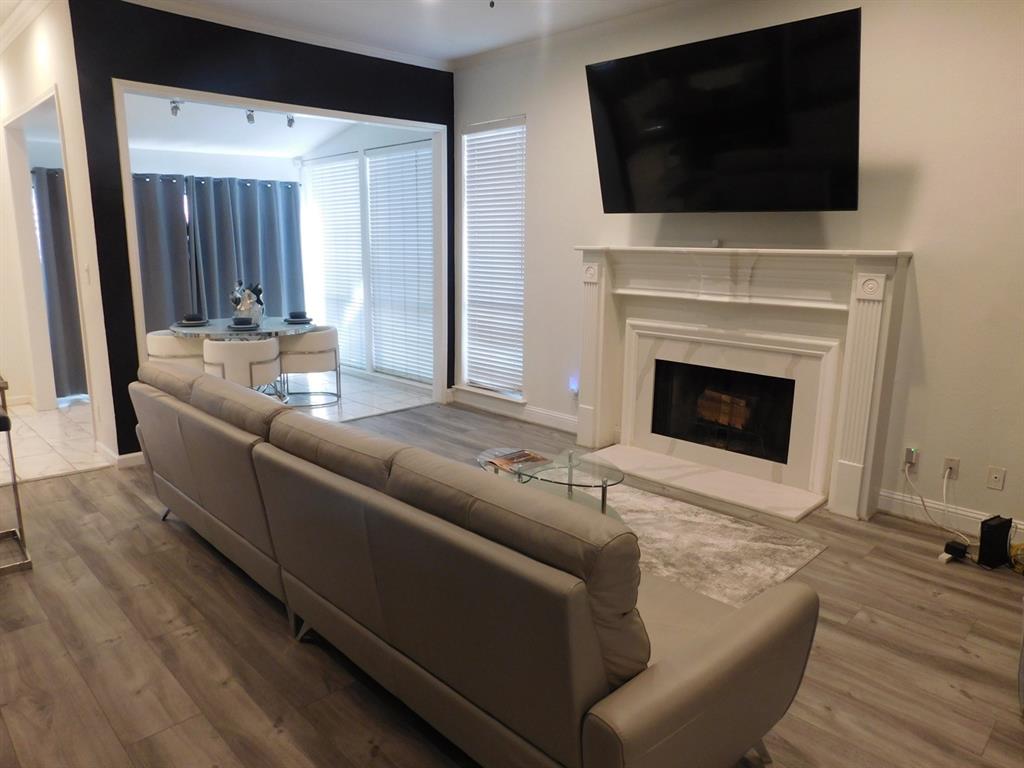 622 Crowley Road Arlington, TX 76012 - Photo 6 of 38 a living room with a fireplace and a flat screen tv