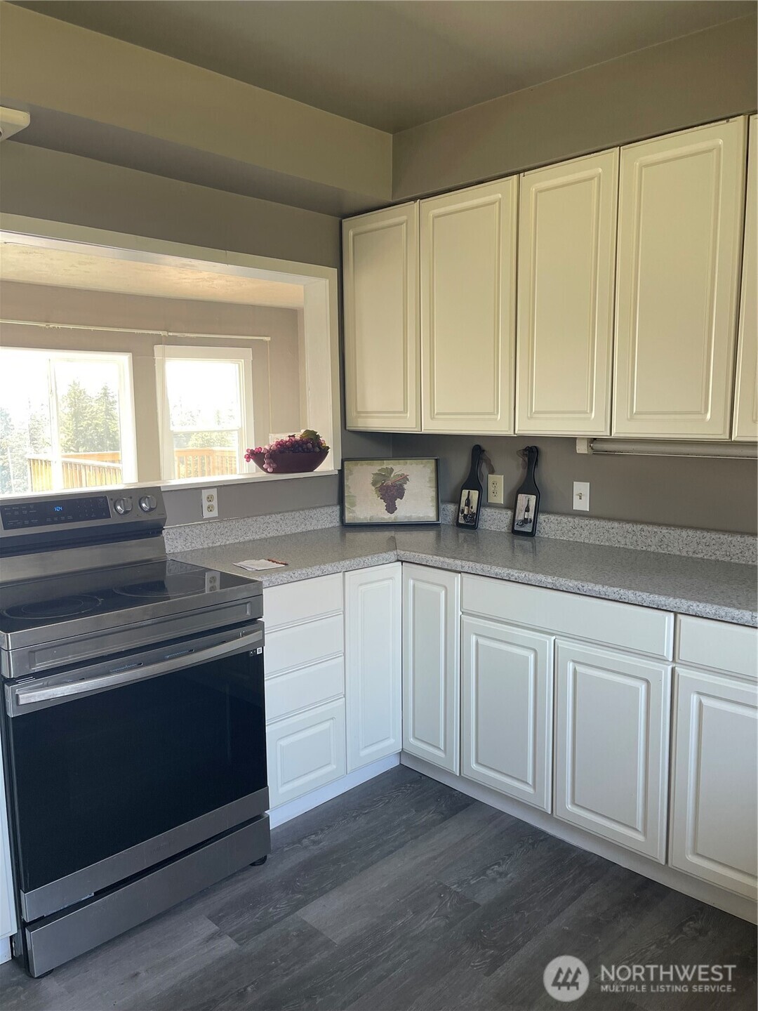 409 2nd Avenue Aberdeen, WA 98520 - Photo 2 of 7 a kitchen with granite countertop white cabinets and white appliances