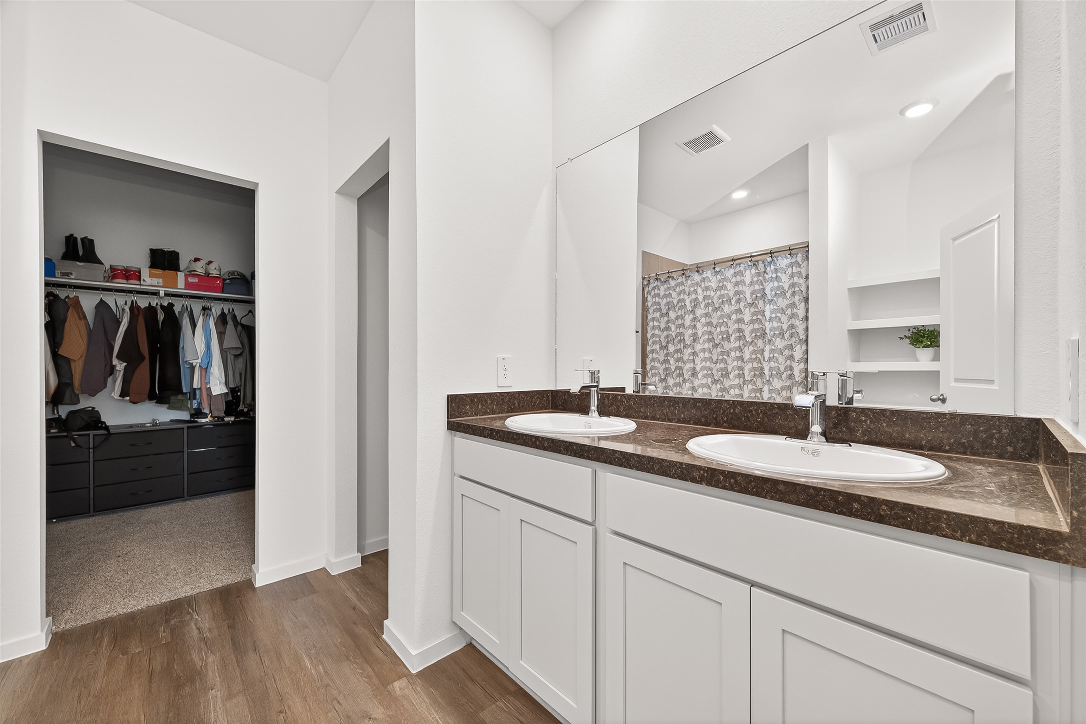 5442 Pinetree Cres Lane Spring, TX 77373 - Photo 10 of 24 The primary ensuite bath features dual sinks, walk in shower, built in storage and a generously sized walk in closet