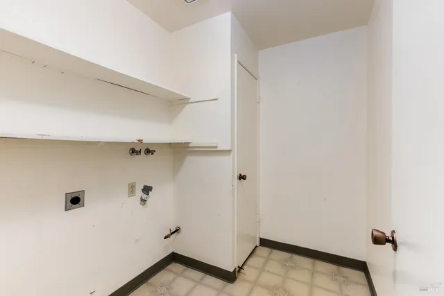 a backyard of a house with plants and wooden fence