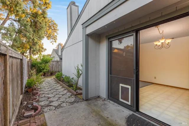 a backyard of a house with table and chairs in patio