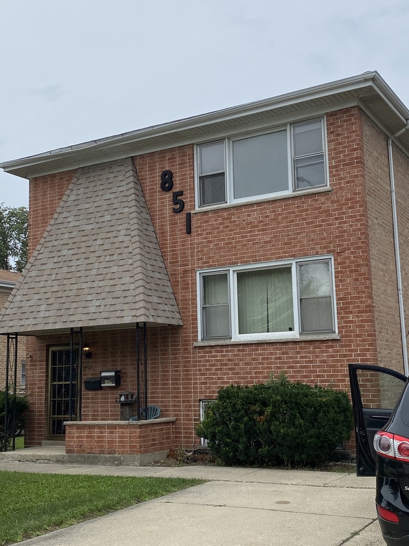 851 Addison Road Addison, IL 60101 - Photo 2 of 25 a front view of a house with garden