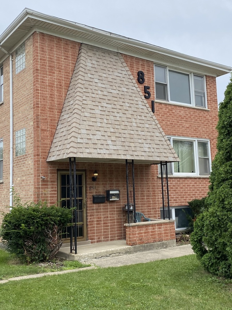 851 Addison Road Addison, IL 60101 - Photo 4 of 25 a front view of a house with a garden and plants