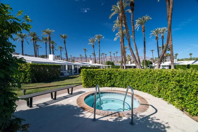 a swimming pool with outdoor seating and yard