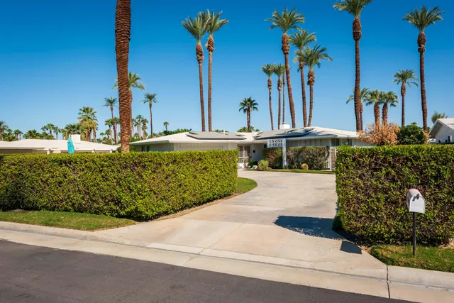 a view of a house with swimming pool and a yard