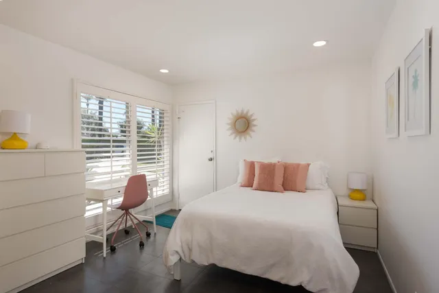 a bedroom with a bed and a window