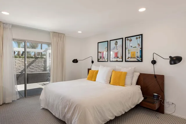 a bedroom with a bed and a large window