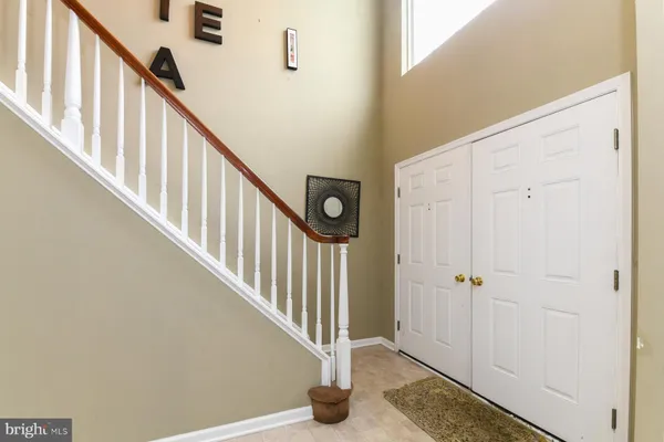 a view of staircase with railing and white walls