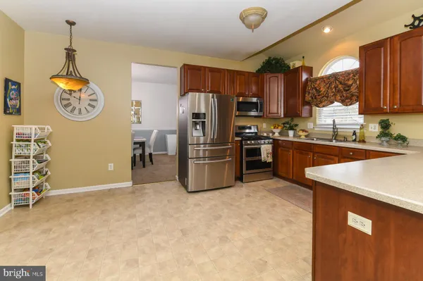 a kitchen with a refrigerator and a sink