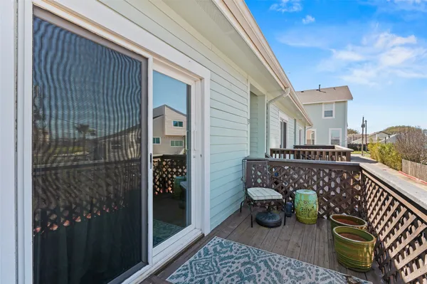 a balcony with furniture and a potted plant