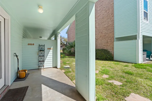 a living room with furniture a chandelier and a table
