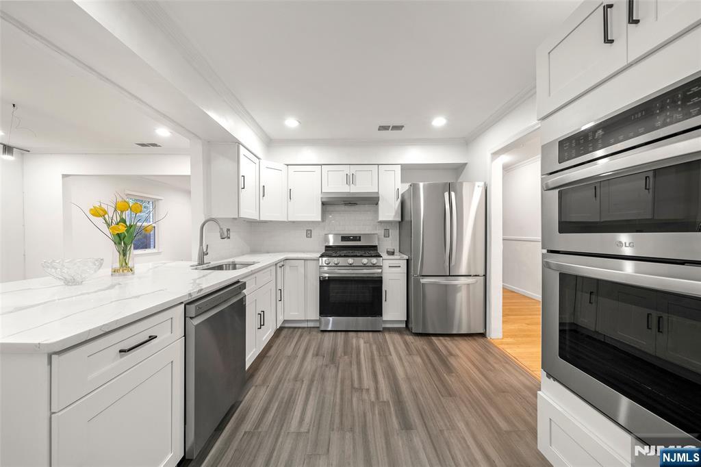 31 Hooks Lane Edgewater, NJ 07020 - Photo 11 of 31 a kitchen with a sink stainless steel appliances and cabinets
