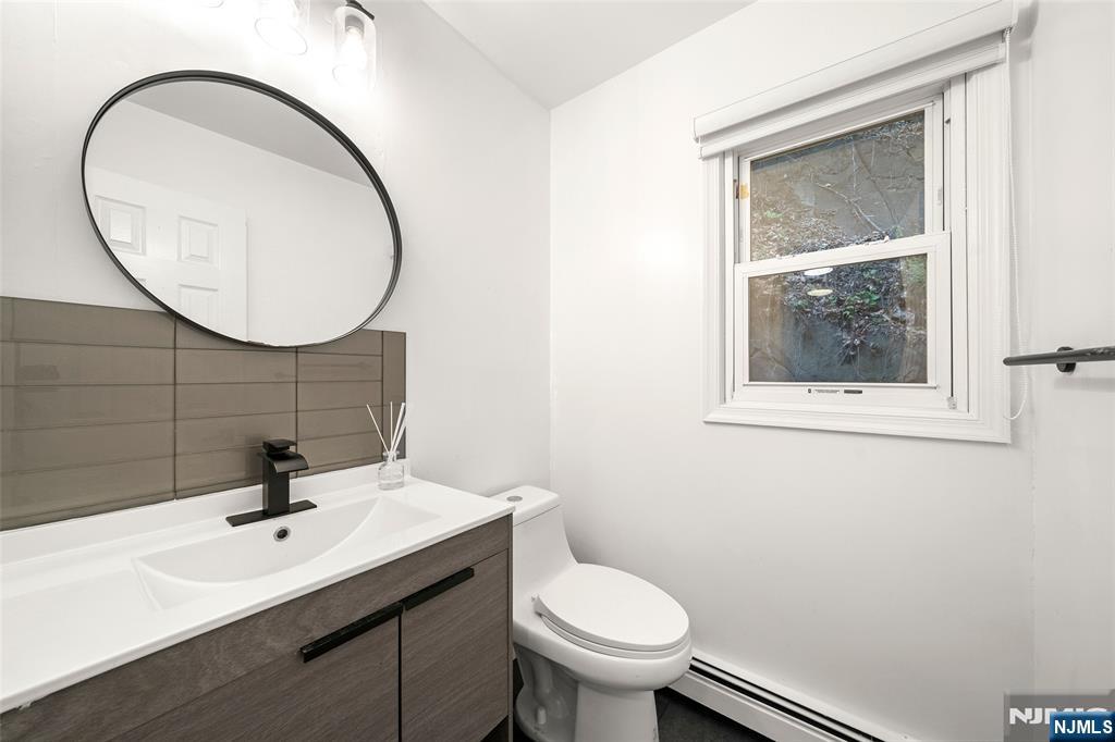 31 Hooks Lane Edgewater, NJ 07020 - Photo 12 of 31 a bathroom with a sink a mirror and a toilet