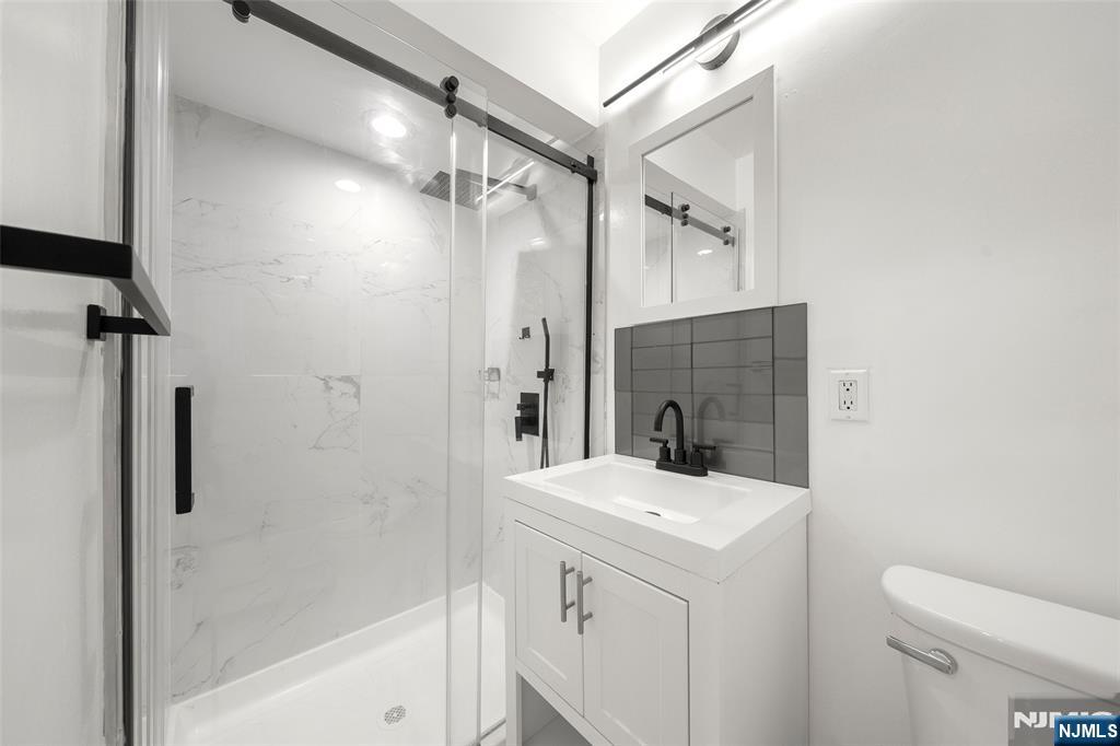 31 Hooks Lane Edgewater, NJ 07020 - Photo 17 of 31 a bathroom with a sink a toilet and shower