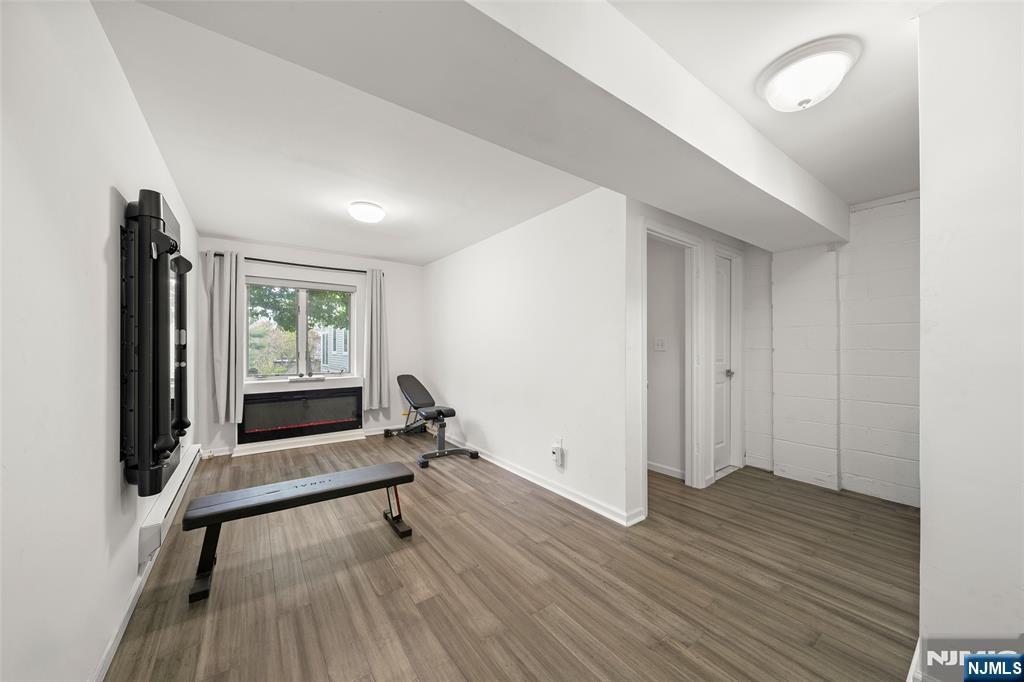 31 Hooks Lane Edgewater, NJ 07020 - Photo 25 of 31 a view of an empty room with a window and wooden floor