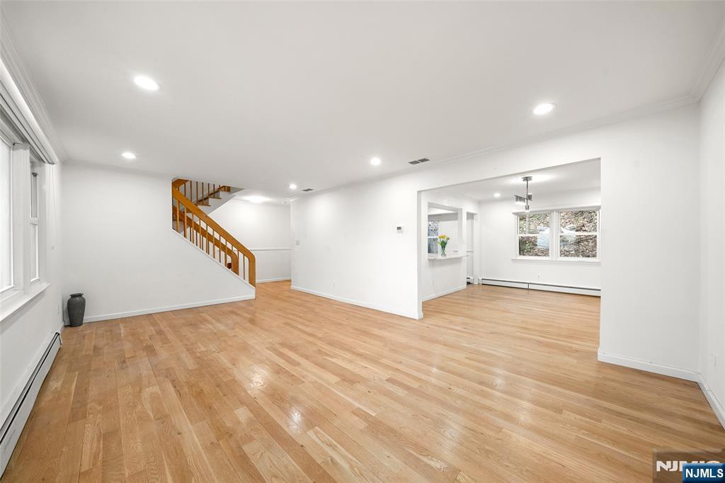 31 Hooks Lane Edgewater, NJ 07020 - Photo 5 of 31 a view of an empty room with wooden floor and a window