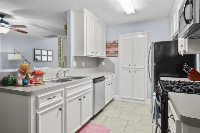 a kitchen with a sink stove and refrigerator