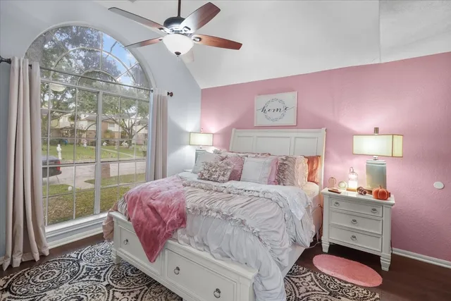 a bedroom with a bed dresser and a window