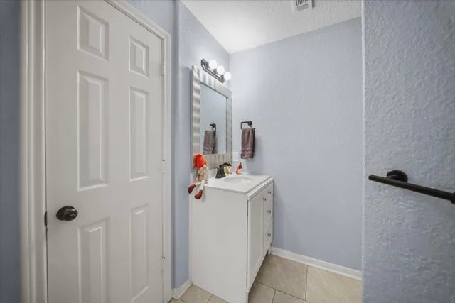 a bathroom with a sink and mirror with shower