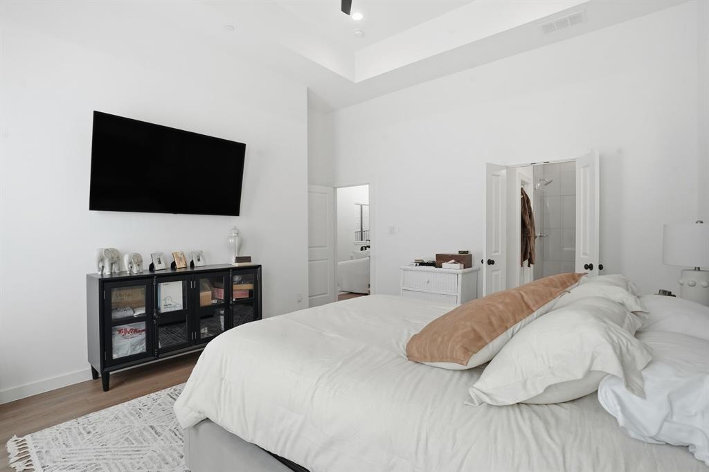 1301 Tillery Court Grapevine, TX 76051 - Photo 11 of 28 a bedroom with a bed and a flat screen tv