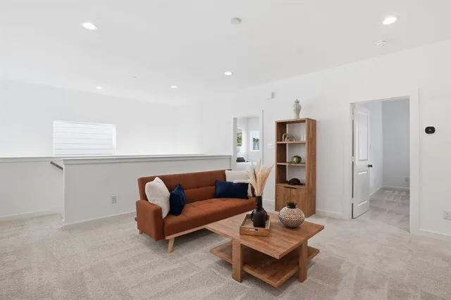 a picture of a living room with furniture and wooden floor