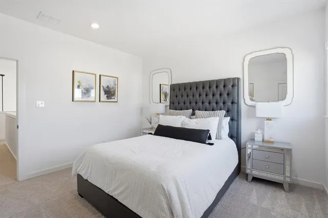 a living room with furniture a refrigerator and cabinets