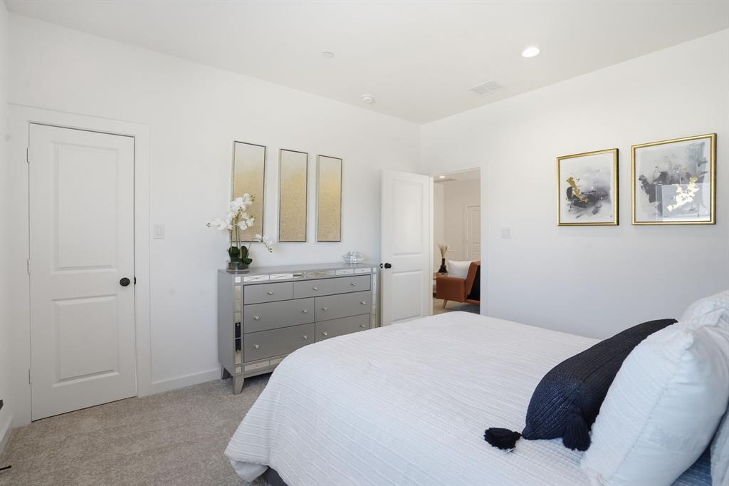 1301 Tillery Court Grapevine, TX 76051 - Photo 21 of 28 a bedroom with a bed and a chandelier