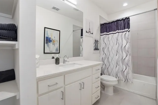 a bedroom with a bed and lamp