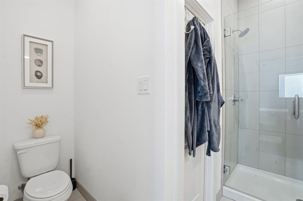 1301 Tillery Court Grapevine, TX 76051 - Photo 25 of 28 a bathroom with a toilet and a shower